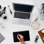 Mastering the First Impression: Your intriguing post title goes here A stylish overhead view of a creative workspace featuring digital devices, drawing tablet, and stationery.